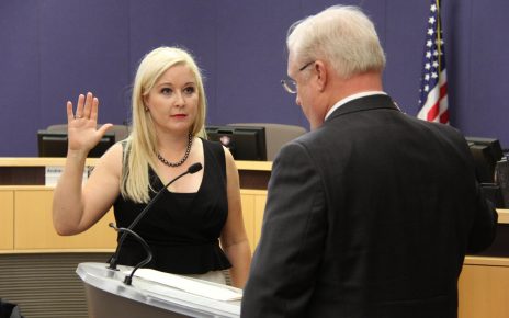 The Honorable Jennifer Ryan-Touhill recites the oath of office at her investiture ceremony in the Board of Supervisors Auditorium in Phoenix, AZ.