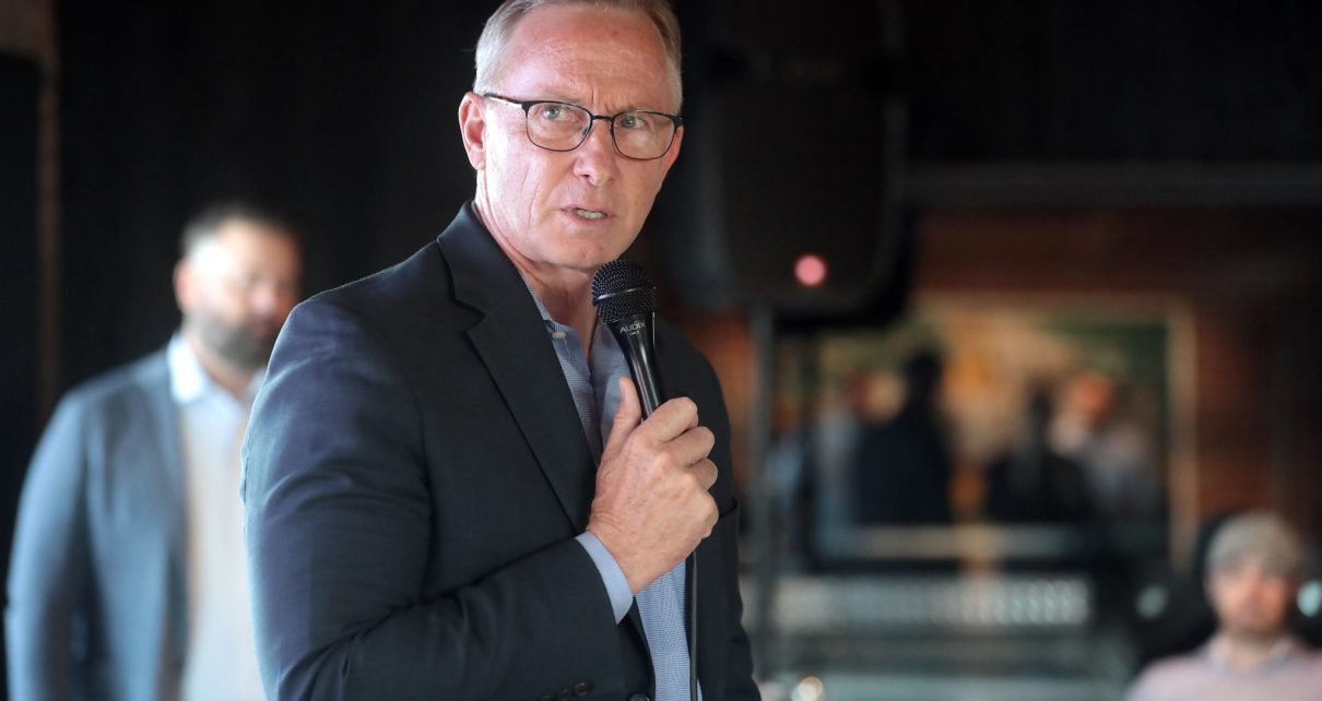 Mesa Mayor John Giles speaking with attendees at a "Yes on 308 Cocktail Hour" event at Cowley Companies in Phoenix, Arizona.