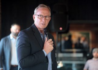 Mesa Mayor John Giles speaking with attendees at a "Yes on 308 Cocktail Hour" event at Cowley Companies in Phoenix, Arizona.